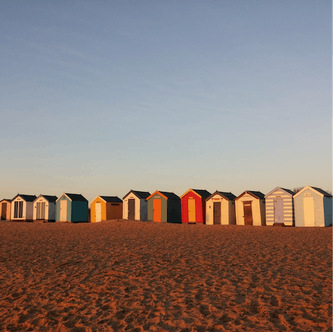 Stroll past the colourful huts on Southwold Beach, a fifteen-minute drive away