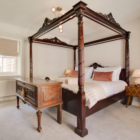 Sleep like royalty in one of the home's two four-poster beds