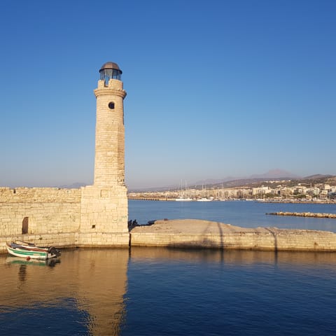 Drive down to Rethymno and visit the iconic lighthouse of the Venetian harbour
