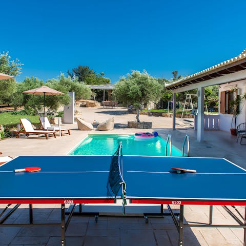 Embrace your competitive side with a game of ping pong by the pool