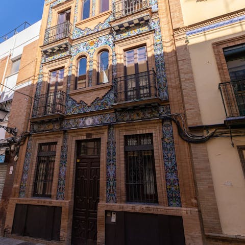 Admire the Spanish ceramic tiles on this building's facade