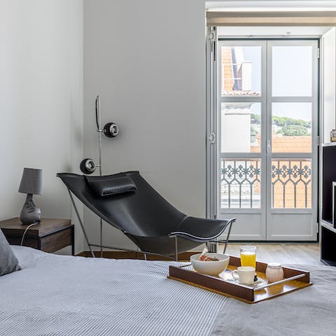 Relax and unwind on the bedroom's designer chair while listening to the street music drifting through the French doors