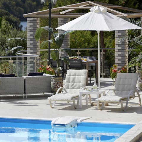 Lie back on the sun loungers in the shade of parasols, drink in hand as the kids play in the pool