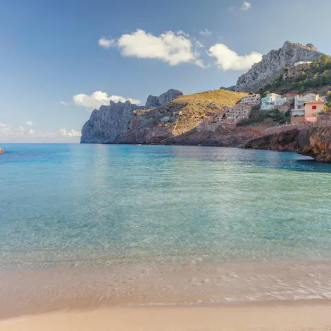 Spend lazy beach days at Cala San Vicente, a seven-kilometre drive away