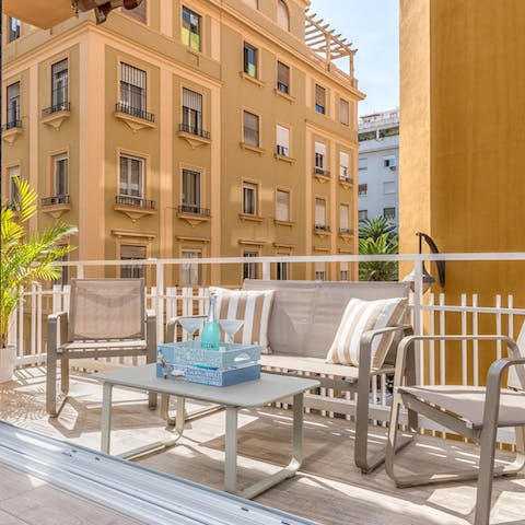 Sit out on the apartment's balcony with something ice-cold in your hand