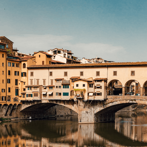 Walk through the atmospheric central streets to Ponte Vecchio