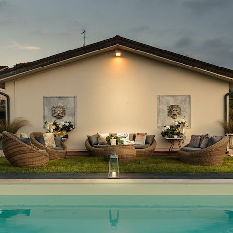 Lounge and socialise outdoors by the pool, letting the drinks flow into the evening