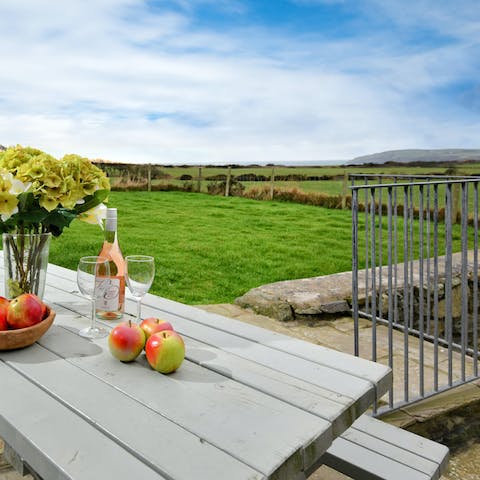 Catch a glimpse of the sunset from the tiered terrace with sundowners