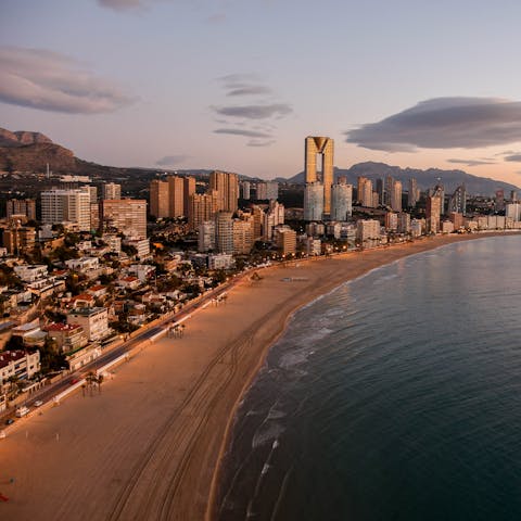 Discover Costa Blanca's vibrant golden shores, just a twenty-minute walk away