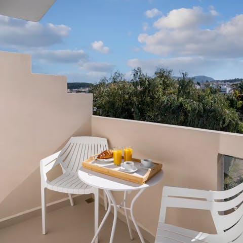Sit down for a sunny breakfast on the private balcony