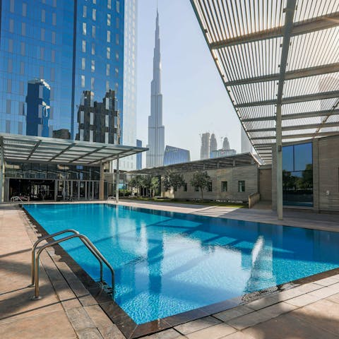 Swim in the communal pool as skyscrapers tower around you