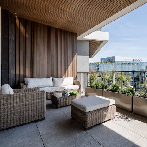 Sip a sundowner on the private balcony while admiring rooftop views over Milan