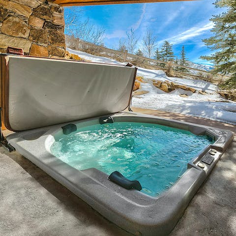 Take in the mountain view from the sunken hot tub