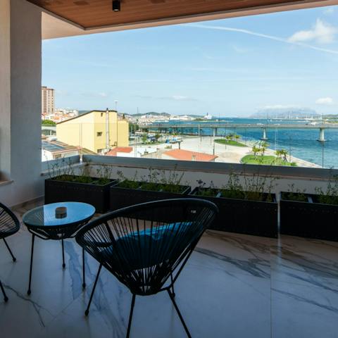 Toast the day's end with drinks on the balcony overlooking the Gulf of Olbia