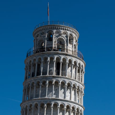Visit the Leaning Tower of Pisa, a twenty-five-minute walk away