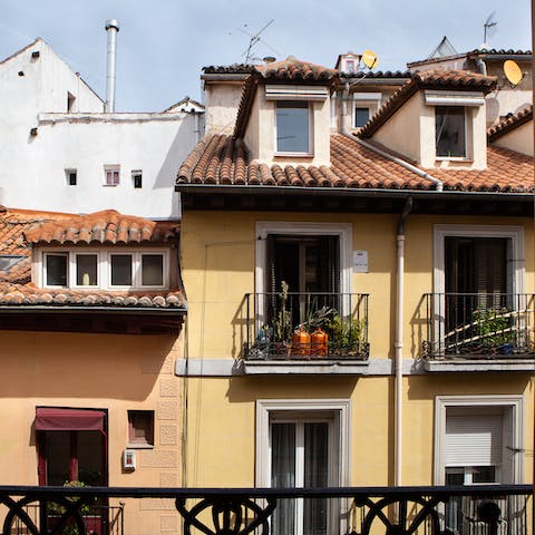 Open the glass door in one of the bedrooms and look out over the balcony to a view of La Latina