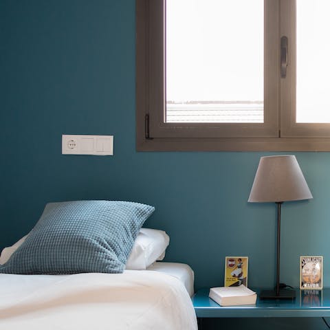 Find a relaxing space in the bedroom with calming blue tones