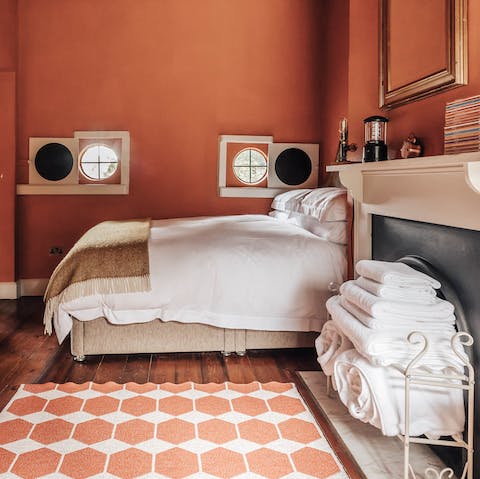 Get a restful night's sleep in a bold terracotta bedroom