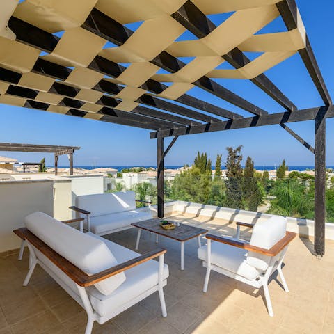 Enjoy the sea views from the private rooftop terrace with cold drinks in the shade