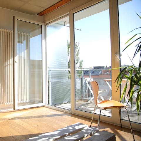 Throw open the glass doors on sunny days and relax in the light-filled living space