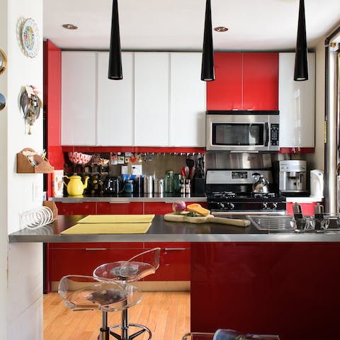 Enjoy your morning coffee at the breakfast bar in the hip red kitchen