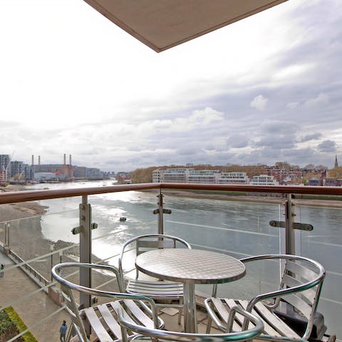 Enjoy an aperitif while soaking up the riverside views on the balcony 