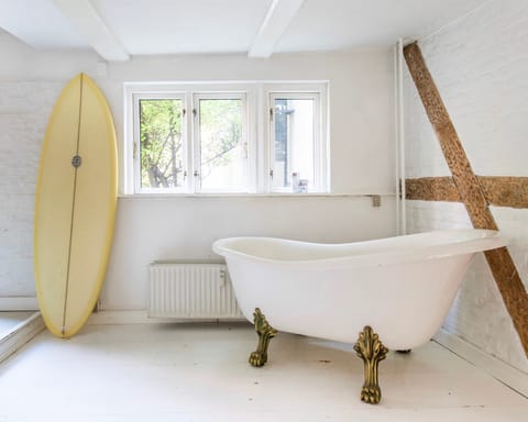 Line the vintage bathtub with a duvet for a comfortable reading nook