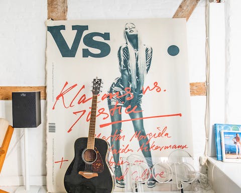 Appreciate the eye-catching posters and beautiful guitars that line the space