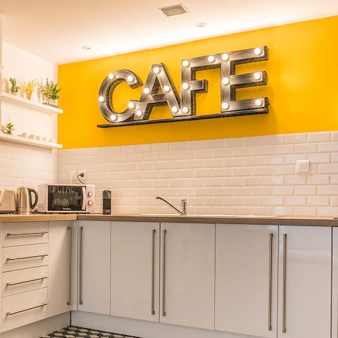 Make your morning coffee in the bold, yellow kitchen with its café sign