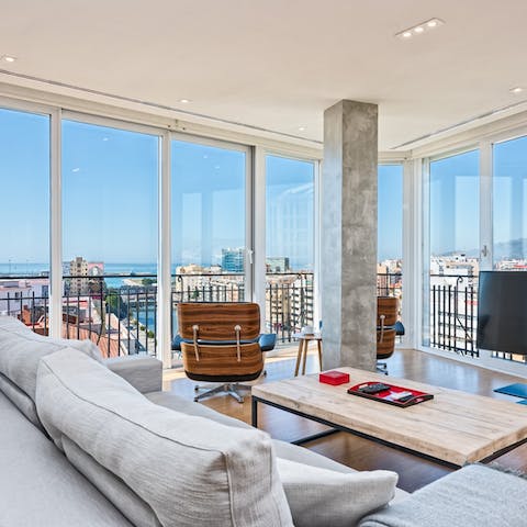 Gaze out over the Málagan skyline from the comfort of the living area's sofas