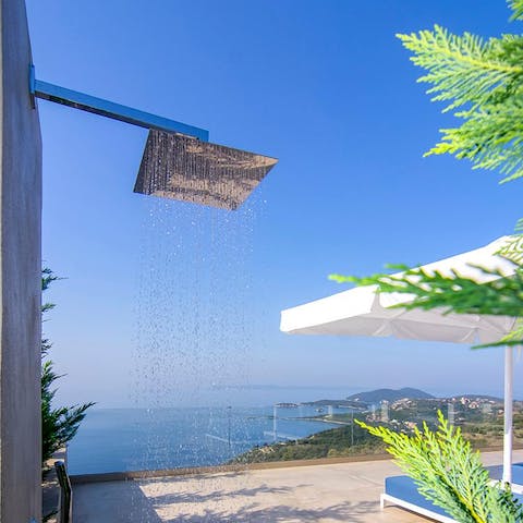 Cool off in the outdoor shower with incredible Ionian views