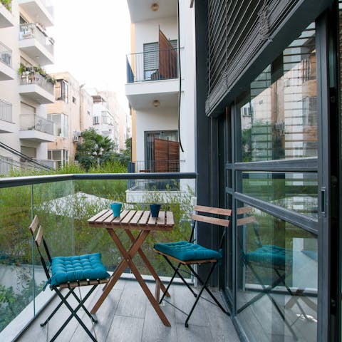 Sip your morning coffee on the private balcony as Tel Aviv wakes below