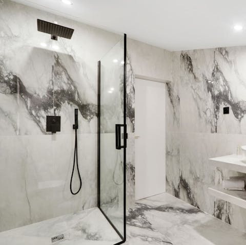 Start mornings with a luxurious soak under the marble bathroom's rainfall shower