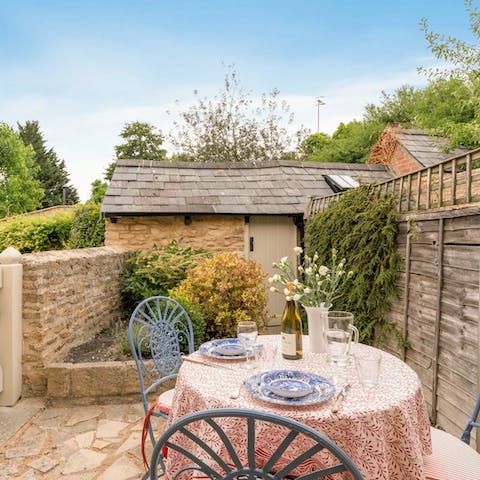 Enjoy a glass of English fizz in the courtyard garden