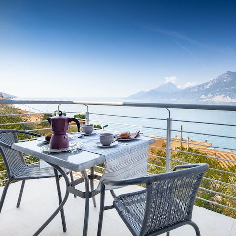 Enjoy breakfast on the balcony while taking in stunning lake views