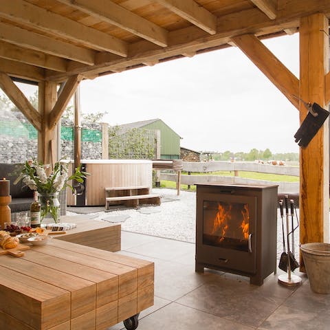 Spend your evenings around the fireplace on the terrace