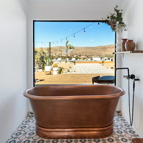 Take a relaxing soak in the freestanding bath tub while enjoying the view