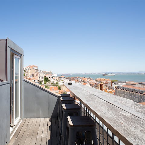 Enjoy incredible views of the Tagus River from your private roof terrace