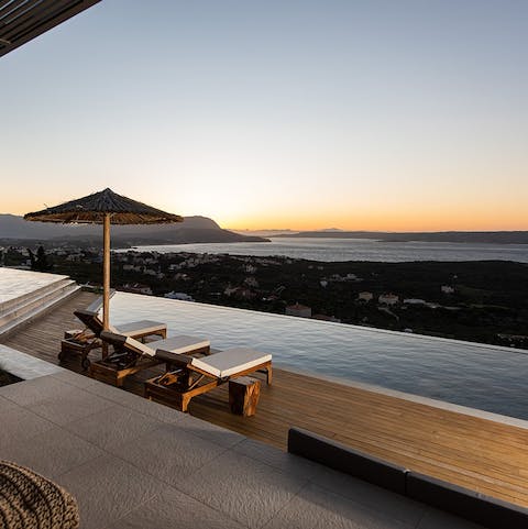 Swim in the heated infinity pool as the sun sets over the bay