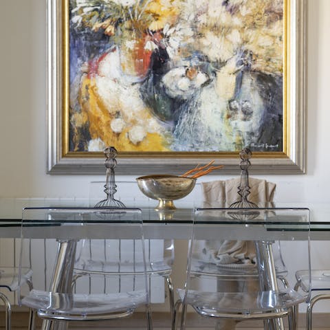 Take in the unique artwork as you dine around the elegant glass table