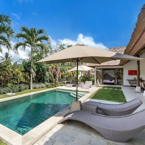 Stretch out under the shade after a dip in the pool