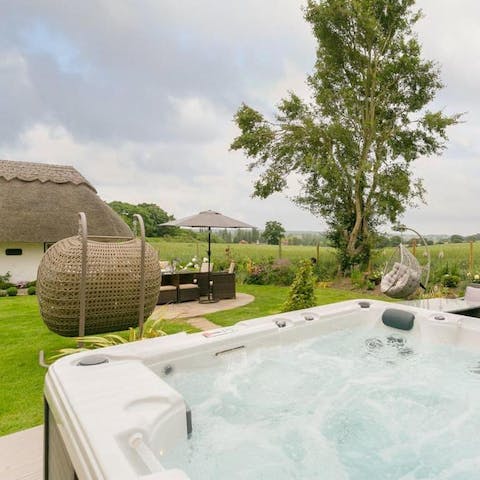 Enjoy a luxurious dip in the six-person hot tub, on a raised deck surrounded by open countryside views
