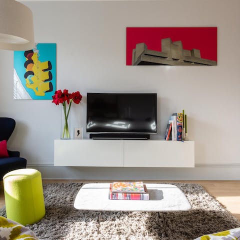 Kick back in the living room with a glass of wine while admiring the colourful art on display