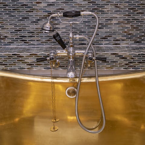 Soak any stresses away in the beautiful brass bathtub