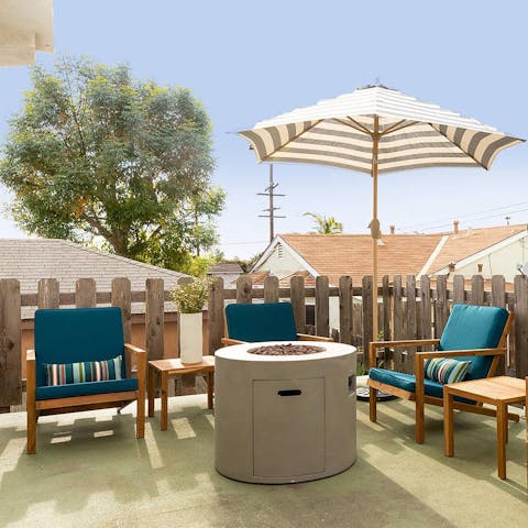 Take a seat around the cosy garden fire pit