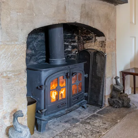 Get cosy by gathering around the wood burner fireplace on chilly evenings
