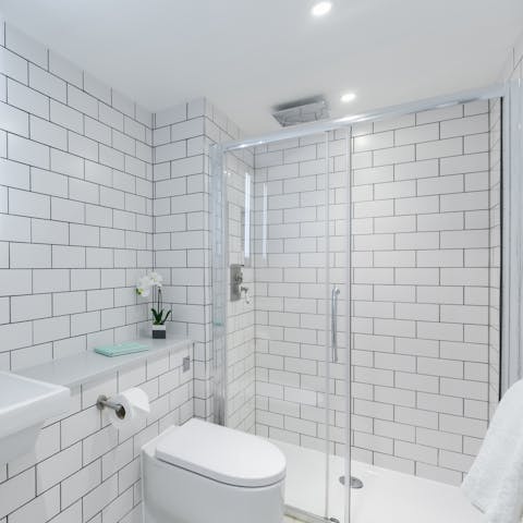 Start mornings with a luxurious soak under the sparkling bathroom's rainfall shower