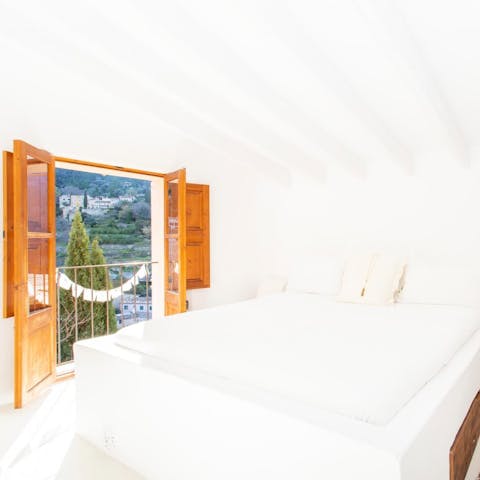 Wake up to sunlight and postcard-perfect scenery in the main bedroom
