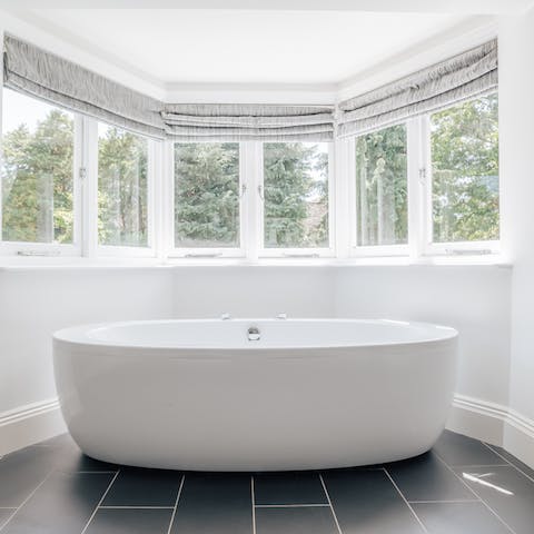 Sink back and relax in the elegant freestanding bathtub by the bay window