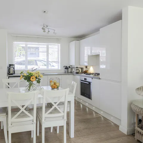 Gather together for breakfast in the bright white kitchen